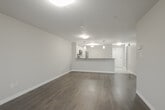 Located at 996 Paisley Rd in Guelph, Ontario, this well-designed one-bedroom, one-bathroom unit offers a thoughtful open-concept layout finished with neutral tones and durable laminate hardwood flooring throughout the main living areas. The kitchen is a standout feature, equipped with white cabinetry, dark countertops, stainless steel appliances including a refrigerator, microwave, and dishwasher, and an extended peninsula with pendant lighting overhead — ideal for casual dining or entertaining. The kitchen flows seamlessly into the combined dining and living area, which is generously proportioned and filled with natural light, with direct sliding door access to a private balcony offering outdoor views. The bedroom is a comfortable, well-sized retreat featuring mirrored sliding closet doors and a window that brings in additional natural light. The full bathroom includes a soaker tub and shower combination with clean, bright finishes. A dedicated in-suite laundry room with full-sized washer and dryer adds everyday convenience. The unit's consistent use of light, neutral walls and clean white trim gives the entire space a fresh, contemporary ambiance throughout.