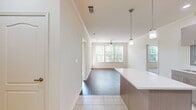 This contemporary 840 square foot apartment offers a well-designed living space with two bedrooms and two bathrooms. The open-concept layout seamlessly integrates the kitchen, living, and dining areas, creating a spacious feel. Large windows throughout flood the rooms with natural light and provide scenic views.

The kitchen is a highlight, featuring modern cabinetry, stainless steel appliances, and a stylish tile backsplash. A central island with a white countertop provides additional prep space and casual seating. The living area boasts wood-look flooring and a ceiling fan for comfort.

The primary bedroom is generously sized at 190 square feet, with plush carpeting and ample natural light. Both bathrooms are well-appointed with modern fixtures, including tub/shower combinations and sleek vanities. The second bedroom also features carpeting and large windows.

Throughout the apartment, neutral tones create a bright and inviting atmosphere. Additional amenities include in-unit laundry and a closet for storage. This thoughtfully designed space offers a perfect blend of style and functionality for modern living.