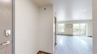 Located on Main Ave in Moorhead, MN, this 2-bedroom, 2-bathroom residence offers a practical and comfortable single-floor layout with a clean, neutral aesthetic throughout. The open living area is bathed in natural light from large sliding glass doors that lead to a private balcony with outdoor views, complemented by light hardwood-style flooring that adds warmth to the space. The kitchen is well-appointed with warm-toned cabinetry, a full suite of stainless steel appliances including a refrigerator, range, microwave, and dishwasher, recessed lighting, and a seamless flow into the living area. Both bedrooms feature plush carpeting, generous natural light from windows overlooking the surrounding neighborhood, and wood-paneled bi-fold closet doors providing ample storage. The primary bedroom offers a comfortable and well-proportioned retreat. The two bathrooms are finished with light wood-look flooring and wood-toned vanities; one includes a walk-in shower and the other a full soaking tub. A dedicated in-unit laundry area houses a full-size top-loading washer and dryer with overhead shelving. A connecting hallway ties the layout together efficiently, making this a well-organized and move-in-ready home.