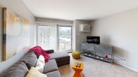 Located at 152 Gladstone Dr in Glendale Heights, Illinois, this single-floor residence offers a practical and well-organized layout. The living room is a comfortable gathering space featuring large sliding glass doors with vertical blinds that invite natural light and provide access to an outdoor balcony area. A wall-mounted air conditioning unit ensures year-round comfort, while carpet flooring adds warmth underfoot.

The kitchen is efficiently designed with rich dark wood cabinetry, light countertops, and black appliances including an electric range with overhead microwave. Wood-look flooring runs throughout the kitchen, which opens conveniently toward the living area.

The primary bedroom features a bold slate-blue accent wall, carpet flooring, a walk-in closet, and a window with natural views. A second bedroom offers a neutral color palette, carpet flooring, a bright window overlooking the exterior, and ample space for a desk and dresser, making it well-suited as a guest room or home office.

The bathroom includes a full tub-and-shower combination with tile surround, a vanity with dark wood cabinetry, and tile flooring. Throughout the residence, neutral wall tones, carpet in living spaces, and consistent finishes create a cohesive and functional living environment.