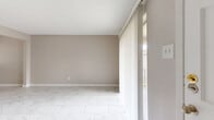 Located at 8100 Bellaire Blvd in Houston, TX, this 2-bedroom, 1-bathroom single-floor unit offers a clean, modern aesthetic carried consistently throughout. Marble-look porcelain tile flooring runs through every room, providing a cohesive and polished look across the entire space.

The living room is bright and open, featuring a sliding glass door that invites natural light and provides access to an outdoor area. The adjacent dining room flows naturally from the living space, maintaining the same neutral warm-gray wall tones found throughout the unit.

The kitchen is laid out in a galley configuration, featuring granite-look countertops, gray cabinetry, a subway tile backsplash, and a window that brings in additional natural light. A pantry provides extra storage convenience nearby.

Both bedrooms are well-proportioned, each equipped with a ceiling fan, a window with blinds for natural light and privacy, and closet space. The primary bedroom is spacious and includes its own dedicated closet. A hallway connects the bedrooms to the shared full bathroom, which features a tub/shower combo with marble-look wall tiles accented by a decorative wood-tone border strip and chrome fixtures.

With four closets total, a pantry, and a textured ceiling throughout, this unit balances practicality with a clean, updated interior aesthetic.