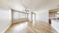 Located in the Southern Highlands community of Las Vegas, this two-story home offers 2 bedrooms and 3 bathrooms across two well-proportioned floors. The main level features an open-concept kitchen and living room with light wood-look flooring and a ceiling fan that keeps the space bright and airy. Large windows with blinds invite abundant natural light, while sliding glass doors provide outdoor access. The kitchen is a standout, boasting granite countertops, a large island with a double sink, warm wood cabinetry, stainless steel appliances including a gas range, built-in microwave, and refrigerator, all illuminated by stylish pendant lighting. A convenient half bathroom with wood-look flooring and a round mirror completes the main level. The attached garage features a clean epoxy-coated floor and an automatic opener. Upstairs, the spacious primary bedroom includes plush carpeting and connects to a well-appointed en suite bathroom with dual vessel sinks, granite countertops, and a walk-in closet. A dedicated laundry room with a full-size washer and dryer adds everyday convenience. The second bedroom also features soft carpeting and a bright window. Neutral tones and consistent finishes throughout create a cohesive, modern aesthetic.