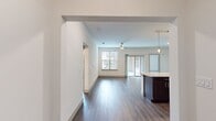 This contemporary 1160 square foot apartment offers a harmonious blend of style and functionality. The open-concept living area boasts sleek wood-look flooring, creating a seamless flow between spaces. The gourmet kitchen is a culinary enthusiast's dream, featuring dark wood cabinetry, stainless steel appliances, and a striking marble-topped island with pendant lighting.

Both bedrooms are generously sized, with the primary bedroom spanning 190 square feet. Plush carpeting in the bedrooms adds comfort underfoot. The two full bathrooms showcase modern fixtures, including a glass-enclosed shower and ample vanity space. A walk-in closet provides abundant storage.

The apartment's in-unit laundry room comes equipped with full-sized washer and dryer. Large windows throughout allow natural light to flood the space, while a ceiling fan in the living area ensures comfort. A private balcony offers outdoor living space and city views.

Located in The Canal complex in Farmers Branch, TX, this apartment combines urban convenience with suburban tranquility. The thoughtful layout and high-end finishes make this space an ideal home for those seeking modern living in a prime location.