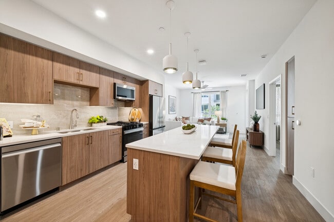 Light wood kitchen with island - AMLI Aero Apartments