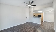 This 860 square foot single-story home in Port Saint Lucie, Florida, offers a well-designed living space with three bedrooms and two bathrooms. The property features a modern kitchen equipped with light wood cabinetry, black appliances, and a convenient layout. The living areas boast wood-look flooring, creating a warm and inviting atmosphere throughout.

The primary bedroom, measuring 160 square feet, provides ample space for relaxation. All bedrooms feature plush carpeting and ceiling fans for added comfort. The bathrooms are fitted with contemporary fixtures, including white vanities and wood-look flooring that complements the overall design.

Large windows in the living area allow natural light to flood the space, while a sliding glass door leads to an outdoor balcony, offering views of the surrounding landscape. The home includes practical amenities such as closet space with wire shelving and a combined kitchen and living room area, ideal for entertaining.

The neutral color palette and clean lines contribute to a modern, low-maintenance living environment. This compact yet functional home in Pine Lakes Boulevard provides a comfortable living space with attention to detail in its finishes and layout.
