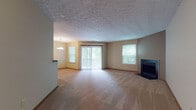 Located at 1604 E Crossings Pl in Westlake, Ohio, this single-floor residence offers a practical and comfortable layout throughout. The expansive living room serves as the heart of the home, featuring a fireplace, plush carpeting, and a textured ceiling. Multiple windows and a sliding glass door with vertical blinds allow generous natural light to fill the space, creating a bright and welcoming atmosphere.

Adjacent to the living room, the dining area is illuminated by a pendant chandelier and benefits from additional natural light through a window and the nearby sliding door. A breakfast bar with a granite-style countertop connects the dining area to the kitchen, which is equipped with white appliances including a refrigerator, electric range, built-in microwave, and dishwasher. Light wood cabinetry and tile flooring complete the functional kitchen space.

The bedrooms are carpeted and well-proportioned, each featuring textured ceilings, wood-trimmed doors, and windows that bring in outdoor views. Two full bathrooms serve the residence, both offering a tub-shower combination, tile flooring, and vanity with ample counter space. Wood-trimmed doors and warm neutral tones are consistent throughout, lending the home a cohesive and understated character.