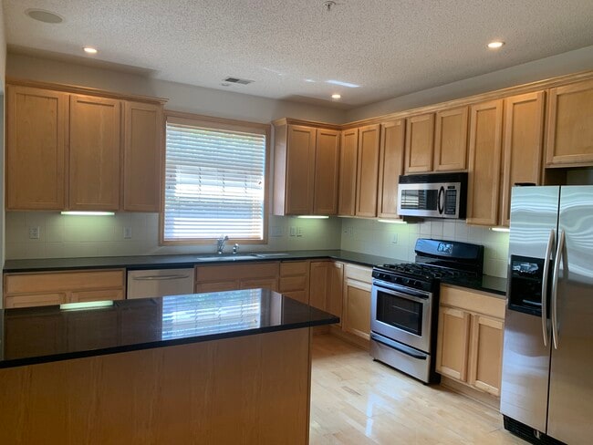 Stainless steel appliances, gas range, upgraded cupboards. So much space in this kitchen! - 1530 Zarthan Avenue South