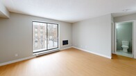 Located at Adair Court in Windsor, Ontario, this one-bedroom, one-bathroom unit offers a thoughtfully designed layout across a single floor. Light-toned laminate flooring runs continuously throughout the space, lending a clean and cohesive aesthetic.

The open-concept living, dining, and kitchen area forms the heart of the unit. The living room is bright and airy, benefiting from a large sliding glass door that opens onto a private balcony, allowing natural light to fill the space and providing outdoor views of the surrounding neighbourhood. The kitchen is outfitted with sleek white cabinetry, dark countertops, and stainless steel appliances including a refrigerator and electric range, offering both style and functionality.

The bedroom provides a comfortable and well-sized private retreat, while a dedicated closet offers practical storage. The bathroom features light tile flooring, a vanity with an integrated sink, a large mirror, and a clean, neutral colour palette throughout.

The entrance provides a welcoming transition into the unit, and the textured ceiling detail adds a subtle architectural element visible across the main living areas. Overall, the unit presents a bright, neutral, and move-in-ready space suited for comfortable everyday living.
