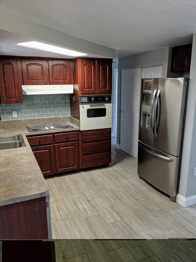 Kitchen view with subway tile backsplash and granite-look counters - 1147 Jennings Dr