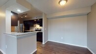 Located at 1551 Causeway Dr. in Dayton, Ohio, this single-floor residence offers a well-designed layout that balances comfort and functionality. The kitchen is a standout feature, outfitted with dark espresso cabinetry, granite-style countertops, stainless steel and black appliances, a track lighting system, and a peninsula that opens to the adjacent dining and living areas. Hardwood-style flooring flows throughout the kitchen and main living spaces, lending a warm, cohesive feel.

The living room is bright and inviting, highlighted by a brick-surround fireplace with a wood mantle that serves as a natural focal point. A sliding glass door provides access to an outdoor area and allows natural light to fill the room. Plush carpeting continues into the bedrooms, each of which features neutral-toned walls, windows that bring in natural light, and six-panel interior doors.

The bathroom is clean and functional, featuring a tiled tub-shower combination, a dark vanity with a light countertop, hardwood-style flooring, and brushed nickel fixtures. Throughout the residence, a consistent neutral color palette and textured ceilings create a calm, move-in-ready atmosphere suitable for a range of lifestyles.