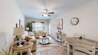Located in Clarksville, Tennessee, this single-floor, 2-bedroom, 2-bathroom residence offers a thoughtfully designed layout that balances comfort and functionality. The open-concept living, dining, and kitchen area serves as the heart of the home, featuring warm wood-look flooring, neutral tones, and ceiling fans that enhance the bright, airy atmosphere. Large windows invite natural light into the living room, which flows seamlessly into the dining area. The kitchen is well-equipped with gray shaker-style cabinetry, white countertops, stainless steel appliances including a French door refrigerator, electric range, microwave, and dishwasher, all complemented by durable wood-look flooring. The spacious primary bedroom features a tray ceiling, a ceiling fan, plush carpeting, and access to a closet and en-suite bath. The second bedroom also boasts a tray ceiling, ceiling fan, carpeted floors, and a window with natural light. Both bathrooms are finished with gray cabinetry and wood-look flooring, with the secondary bath offering a tub-shower combination. Additional spaces include a hallway, laundry area, and closet, rounding out a complete and practical floor plan.
