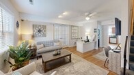 Located at 3609 Wilmington Ave in Hopewell, Virginia, this two-story home presents a well-organized and warmly appointed interior spread across two levels. Hardwood flooring runs throughout the majority of the home, lending continuity and warmth to each space.

The main living area is bright and inviting, featuring a ceiling fan, recessed lighting, plantation shutters, and a reception-style built-in desk, giving the front room a versatile, functional character. Adjacent to this is a comfortable sitting room with natural light streaming through a window, neutral tones, and tasteful wall décor that creates a relaxed atmosphere.

The kitchen is well-equipped with rich wood cabinetry, granite-style countertops, stainless steel appliances including a range, microwave, and dishwasher, and a window above the sink. A separate dining area accommodates a dining table and opens conveniently to adjacent rooms.

The bedrooms are generously proportioned, each offering natural light through large windows, hardwood floors, and soft, neutral wall colors. The primary bedroom features sage-toned walls and ample space, while additional bedrooms are finished in light gray tones.

The bathrooms include white subway tile detailing, natural light from windows, and wood-toned vanity cabinetry. A half bath provides added convenience. Overall, the home exudes a clean, comfortable, and well-maintained ambiance.