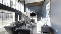This striking single-floor space makes an immediate impression with its dramatic double-height ceilings that amplify the sense of openness and grandeur. The living area is anchored by a sleek, wall-mounted fireplace framed in light stone tile, above which a flat-screen television is centrally positioned for an integrated entertainment experience. A warm wood-paneled accent detail at the upper ceiling level provides a natural contrast to the cool, steel-blue walls that define the room's sophisticated color palette. Large floor-to-ceiling windows flood the interior with generous natural light, casting dynamic shadows across the space throughout the day. The furnishings are carefully curated in complementary shades of grey and charcoal, including plush sofas, a tufted ottoman, and sleek accent chairs, all arranged to encourage conversation and comfort. A bold large-scale portrait artwork adorns one wall, adding an artistic focal point that reinforces the contemporary aesthetic. Decorative wall texturing and industrial-style pendant lighting contribute additional layers of visual interest. The overall ambiance is modern and refined, combining clean architectural lines with carefully chosen design elements to create a cohesive, stylish, and inviting environment.