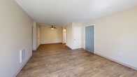 Located at 650 SW 201st Ave in Aloha, Oregon, this well-appointed 2-bedroom, 2-bathroom unit offers a practical and comfortable single-floor layout. The open living and dining area greets you with warm wood-look flooring, a ceiling fan, neutral beige walls, and a sliding glass door that fills the space with natural light and provides direct access to an outdoor patio with neighborhood views. Adjacent to the living area, the kitchen features white cabinetry, granite-style countertops, a stainless steel sink, and a window that brings in additional natural light.

Both bedrooms are carpeted and bright, with windows dressed in vertical blinds. The generously sized primary bedroom includes a dedicated walk-in closet outfitted with dual hanging rods for ample storage. The second bedroom also features a closet and a baseboard heating unit. Each of the two bathrooms is finished with wood-look tile flooring, a white vanity with granite-style countertops, a large mirror, and brushed nickel fixtures, delivering a clean and consistent aesthetic throughout. The neutral color palette and consistent finishes across all rooms create a cohesive, move-in-ready atmosphere suited for a variety of lifestyles.