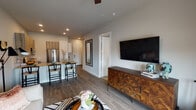 This thoughtfully designed one-bedroom, one-bathroom residence in Houston, TX (77008) offers a well-appointed single-floor layout that balances modern aesthetics with everyday functionality. The open-concept living and dining area flows seamlessly together, anchored by wood-look plank flooring, recessed lighting, and a ceiling fan. A large wall-mounted TV and a geometric-patterned dresser add character to the living space, while French doors with floor-to-ceiling drapes open to a private balcony, filling the room with natural light and offering outdoor views.

The kitchen is a standout feature, equipped with wood-toned cabinetry, a white subway tile backsplash, stone-look countertops, and a full suite of stainless steel appliances including a French door refrigerator, range, and built-in microwave. A peninsula with seating for multiple bar-height chairs serves as both a prep area and casual dining spot.

The bedroom is a calm retreat with plush carpeting, large windows with roller shades, a ceiling fan, and ample natural light. The full bathroom is finished with large-format tile flooring, a single vanity with a light stone countertop, and a glass-enclosed walk-in shower, rounding out this well-crafted residence.