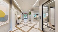 Located at 1000 Cowpen Ct in Williamsburg, Virginia, this thoughtfully designed single-floor amenity space offers a refined blend of comfort and functionality. The welcoming hallway sets an impressive tone with its striking marble-patterned tile flooring accented by wood inlays, recessed linear LED lighting, and elegant decorative wall art — creating a polished first impression upon entry.

The combined kitchen and living area serves as the social hub of the space. The kitchen features granite countertops, modern cabinetry with gold hardware, stainless steel appliances, and a central island with bar seating — all bathed in natural light from garden-view windows. The adjoining living area is generously furnished with contemporary seating, wall-mounted televisions, and large windows dressed with white blinds that frame lush outdoor greenery. Topiary arrangements in tall sculptural planters add a refined botanical touch throughout.

The dedicated exercise room is comprehensively equipped with treadmills, stationary bikes, elliptical machines, cable machines, free weights, and resistance equipment. Ceiling fans, linear LED lighting, and multiple wall-mounted screens enhance the workout experience, while windows provide natural light and outdoor views. Together, these areas create a versatile, upscale amenity space suited for both relaxation and active living.