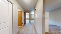 Located at 206 E 15th Ave in Ellensburg, WA, this one-bedroom, one-bathroom unit offers a practical and efficiently designed single-floor layout. A carpeted hallway serves as the central spine of the home, connecting all rooms and providing a clean, cohesive flow throughout the space.

The living room is comfortably sized with soft carpet flooring, neutral-toned walls, and a window that allows natural light to fill the room while offering views of the surrounding neighborhood. A wall-mounted HVAC unit ensures year-round climate control.

The kitchen is well-appointed with warm wood cabinetry, dark granite-style countertops, a stainless steel sink, and white appliances including an electric range, dishwasher, and range hood. Tile flooring adds durability and easy maintenance to this functional cooking space.

The bedroom features plush carpet, sliding wood-panel closet doors providing ample storage, and a window that brings in natural light. Its straightforward layout accommodates a variety of furniture configurations.

The bathroom is clean and functional, featuring a full tub-shower combo, a wood-vanity with dark countertop, tile flooring, and bright white fixtures throughout. The overall design is practical and well-maintained, making this unit a solid option in the Ellensburg area.