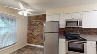 Located at 59 Fitzhenry Blvd in Columbus, Ohio, this two-floor residence offers a well-appointed layout with a blend of functional design and character-rich details. The kitchen is a standout space, featuring stainless steel appliances — including a refrigerator, range, and over-the-range microwave — complemented by white shaker-style cabinetry, wood-look vinyl plank flooring, and a striking exposed brick accent wall that adds warmth and texture to the space. A ceiling fan provides additional comfort in this area. The multiple bedrooms are generously sized, each finished with plush carpeting, neutral wall tones, and ceiling fans with integrated lighting. Several bedrooms benefit from natural light through windows fitted with blinds, offering views of the surrounding greenery. Select bedrooms include closets with built-in shelving for ample storage. The bathroom is clean and functional, featuring a full tub-shower combo, a white vanity, and wood-look vinyl flooring that ties cohesively to the rest of the home. The overall layout, as shown in the floorplan view, provides a practical multi-room configuration across two levels, making this a comfortable and versatile space in a residential Columbus neighborhood.