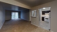 Located at 1613 Locust St in Elkhart, Indiana, this single-floor residence offers a practical and comfortable layout designed for everyday living. The open-concept living and dining area is generously proportioned, featuring plush wall-to-wall carpeting and a sliding glass door fitted with vertical blinds that brings in natural light and provides outdoor access. A pass-through window connects the living space to the kitchen, enhancing the sense of openness throughout.

The kitchen is well-equipped, showcasing rich dark cabinetry that reaches the upper walls, marble-patterned countertops, a gas range, dishwasher, and a stainless steel sink — all set on durable wood-look flooring. The space is both functional and visually cohesive.

The bedrooms are carpeted and neutrally toned, offering generous square footage with natural light from windows dressed in vertical blinds. Each room provides a calm, move-in-ready environment.

The full bathroom features a wide vanity with a large mirror, dark cabinetry, a tub-shower combo, and wood-look tile flooring. A separate half bath provides added convenience for guests.

Throughout the residence, a consistent neutral color palette, clean finishes, and carpet-to-hard-floor transitions create a cohesive and welcoming atmosphere.
