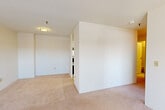 Located at 95 Audubon Rd in Wakefield, MA, this single-floor residence offers three bedrooms, one bathroom, and a thoughtfully arranged layout. The galley-style kitchen is outfitted with white cabinetry extending to the ceiling, white countertops, a stainless steel sink, an electric range, and a dishwasher, all set atop light tile flooring. The efficient design maximizes storage with ample upper and lower cabinet space. The living and bedroom areas feature soft wall-to-wall carpeting and clean white walls that create a bright, neutral atmosphere. The spacious primary bedroom benefits from large windows that invite natural light and offer outdoor views of the surrounding landscape. The additional bedrooms are well-proportioned and include closet access, supported by two dedicated closets throughout the unit. A connecting hallway links the rooms in a practical and organized flow. The full bathroom is finished with a white vanity with under-sink cabinetry, a mirrored medicine cabinet, tile flooring, and a clean, functional layout. Throughout the residence, the consistent use of white and neutral tones contributes to a light, airy ambiance, making the space feel open and easy to personalize.