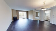 Located at 3156 Oak Rd in Walnut Creek, CA, this single-floor residence offers a thoughtfully designed open-concept layout with a clean, modern aesthetic throughout. Rich dark hardwood flooring flows seamlessly across the main living areas, creating a warm and cohesive atmosphere.

The expansive living room serves as the heart of the home, featuring a classic fireplace with a white mantel and a sliding glass door that opens to a private balcony, filling the space with natural light and views of the surrounding greenery. The living area connects fluidly to the kitchen, which is outfitted with crisp white shaker-style cabinetry, a tile backsplash, light countertops, stainless steel appliances including a gas range, microwave, refrigerator, and dishwasher, and a peninsula that provides additional workspace and separation from the main living area.

The bedroom is generously proportioned, featuring soft carpeting, warm neutral-toned walls, and a large window that frames lush outdoor views. Two full bathrooms are present, each featuring a tub-shower combination with sliding glass doors, white vanities, and clean, neutral finishes. Additional hallway space with closet storage enhances the functional flow of the layout. Overall, the residence presents a bright, well-appointed living environment in a desirable Walnut Creek location.