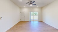 Located at 5543 E NC 150 Hwy in Maiden, NC, this well-appointed single-story home offers three bedrooms, two full bathrooms, and a dedicated laundry room across a comfortable and thoughtfully designed floor plan. The open-concept kitchen and living area serves as the heart of the home, featuring dark shaker-style cabinetry, white quartz countertops, stainless steel appliances, a large center island with pendant lighting, and light wood-look flooring that flows throughout the main living spaces. The kitchen's generous layout provides ample storage and prep space, making it ideal for everyday living. The spacious primary bedroom includes recessed lighting, a ceiling fan, sliding glass doors leading to a private balcony with outdoor views, and a closet with louvered doors. The two additional bedrooms are well-sized, each featuring plush carpet, ceiling fans, and windows that invite natural light and views of the surrounding greenery. Both bathrooms are finished with dark wood vanities, white countertops, and tub-shower combinations with light wood flooring. The dedicated laundry room includes a full-size washer and dryer with built-in wire shelving above. Clean white walls and consistent finishes throughout give this home a fresh, move-in-ready feel.