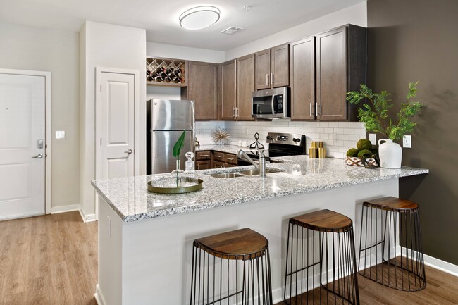 Bright Modern Kitchen with Breakfast Bar - Legacy at Jones Farm Apartments