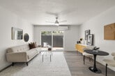 Located at 13130 Carriage Rd in Poway, CA, this thoughtfully updated single-floor residence offers a clean, modern aesthetic throughout. The open-concept living and dining area is anchored by light wood-style flooring, a ceiling fan, and a wall-mounted mini-split system. A sliding glass door floods the space with natural light and provides direct access to a private patio with views of surrounding greenery.

The kitchen is well-appointed with white shaker cabinetry, quartz countertops, stainless steel appliances including a French door refrigerator and dishwasher, a stainless range hood, and a peninsula that adds additional prep and casual dining space.

Two generously sized bedrooms each feature large windows with outdoor views, ceiling fans, and mini-split climate control units, creating bright and comfortable retreats. The primary bedroom includes a dedicated sitting area.

Two full bathrooms are finished in crisp white with wood-tone flooring and matte black hardware accents. One bathroom includes a soaking tub. A stacked in-unit washer and dryer adds everyday convenience.

Consistent wood-style flooring, white walls, and a neutral palette tie the space together, creating a cohesive and inviting atmosphere throughout.