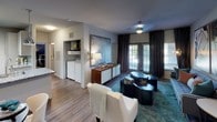 Located at 9410 Long Creek Green Dr in Charlotte, NC, this single-floor residence offers a well-appointed layout designed with modern living in mind. The open living area is highlighted by wood-style flooring, a ceiling fan, and large windows dressed with layered blinds and drapes that allow generous natural light. An in-unit laundry area is conveniently accessible from the living space.

The kitchen is outfitted with crisp white cabinetry, granite countertops, a classic tile backsplash, stainless steel appliances including a range, microwave, and refrigerator, and a deep undermount sink with a gooseneck faucet — combining function with contemporary style.

Multiple bedrooms provide comfortable retreats, each featuring plush carpeting, ceiling fans, and large windows. The primary bedroom includes a walk-in closet, while each room offers ample space for relaxation and personalization.

The bathrooms are finished with granite-topped vanities, wood-style tile flooring, and clean white fixtures. One bathroom features a soaking tub with shower, while another includes a glass-enclosed shower, offering variety and convenience.

Throughout the residence, neutral gray walls and consistent finishes create a cohesive, modern aesthetic, making this Charlotte home a polished and functional living space.