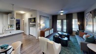 Located at 9410 Long Creek Green Dr in Charlotte, NC, this single-floor residence offers a well-appointed layout designed with modern living in mind. The open living area is highlighted by wood-style flooring, a ceiling fan, and large windows dressed with layered blinds and drapes that allow generous natural light. An in-unit laundry area is conveniently accessible from the living space.

The kitchen is outfitted with crisp white cabinetry, granite countertops, a classic tile backsplash, stainless steel appliances including a range, microwave, and refrigerator, and a deep undermount sink with a gooseneck faucet — combining function with contemporary style.

Multiple bedrooms provide comfortable retreats, each featuring plush carpeting, ceiling fans, and large windows. The primary bedroom includes a walk-in closet, while each room offers ample space for relaxation and personalization.

The bathrooms are finished with granite-topped vanities, wood-style tile flooring, and clean white fixtures. One bathroom features a soaking tub with shower, while another includes a glass-enclosed shower, offering variety and convenience.

Throughout the residence, neutral gray walls and consistent finishes create a cohesive, modern aesthetic, making this Charlotte home a polished and functional living space.