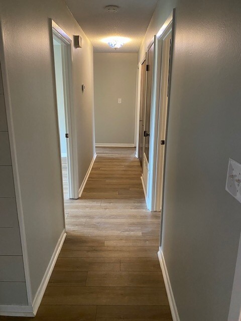 View from entrance to hallway accessing bedrooms. - 607 King Arthur St
