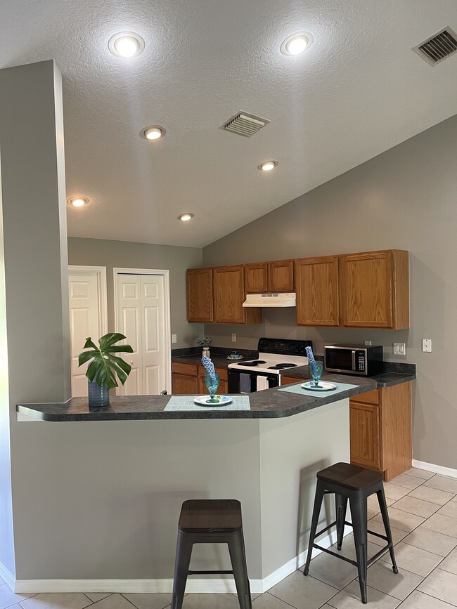 Kitchen/Breakfast Bar Area - 11177 Airport Dr
