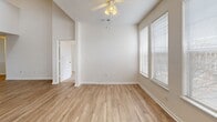 This two-story townhouse in Raleigh, NC offers 1650 square feet of living space, thoughtfully divided between two floors. The ground floor, spanning 1160 square feet, hosts the main living areas. It features an open-concept design, combining the kitchen and living room for a spacious feel. The kitchen is equipped with modern appliances, including a microwave and electric range, and boasts ample wood cabinetry and contrasting countertops.

Upstairs, 490 square feet accommodate two bedrooms, including a generous 160-square-foot primary bedroom. The upper level is characterized by plush carpeting and high ceilings, with some areas benefiting from skylights that flood the space with natural light. Ceiling fans in bedrooms provide added comfort.

Both bathrooms feature tiled floors and tub/shower combinations. The home includes practical amenities such as a dedicated laundry area and closet space with wire shelving. Throughout the property, a neutral color palette creates a bright, airy atmosphere. Some areas showcase hardwood flooring, adding a touch of warmth to the overall design. Large windows in various rooms offer ample natural light and potential views of the surrounding area.