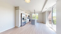 Located at 138 N Haven Rd in Elmhurst, IL, this single-floor home offers four bedrooms, two bathrooms, and a thoughtfully designed layout. The open-concept kitchen serves as a central hub, featuring white shaker cabinetry, stainless steel appliances including a French door refrigerator and range, and a sizeable island with a clean white countertop and pendant lighting overhead. Large windows frame tree-lined outdoor views, flooding the space with natural light. Sliding glass doors provide access to an outdoor area with views of the surrounding neighborhood.

Light wood-look flooring runs throughout the main living and kitchen areas, while soft carpet covers the bedrooms, adding comfort underfoot. The hallways are clean and well-lit, connecting rooms with an efficient, linear flow. The generously sized primary bedroom features multiple large windows that draw in abundant daylight and offer pleasant greenery views.

Both bathrooms are finished in a modern, minimalist style with white cabinetry, black hardware accents, and frameless mirrors. One bathroom includes a walk-in shower with a black-framed glass door and white tile surround. The overall aesthetic throughout is contemporary and neutral, with a clean, move-in-ready presentation.