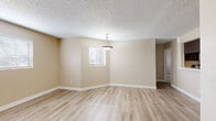 Located at 150 S Roosevelt Rd in Mesa, AZ, this single-story home offers a practical and comfortable layout with three bedrooms, two bathrooms, a kitchen, a living room, and a dedicated closet. The interior is finished with warm, neutral-toned walls and textured ceilings throughout, creating a cohesive and inviting ambiance.

The kitchen is well-appointed with rich dark wood cabinetry, light countertops, a stainless steel refrigerator, range, microwave, and dishwasher, all set over light vinyl plank flooring. The living and dining areas are open and bright, benefiting from multiple windows with blinds that allow natural light to filter in, complemented by a stylish pendant light fixture.

The primary bedroom is a comfortable size and features its own closet, carpeted flooring, and natural light from a window. The additional bedrooms are also carpeted, with neutral walls and windows. One bedroom includes sliding door access to an outdoor area.

Both bathrooms are clean and functional, each featuring a tub-shower combination, white fixtures, and vanity with sink. The light vinyl plank flooring in one bathroom adds a modern touch, while the overall design remains consistent and practical throughout the home.