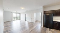 Located at 606 Elizabeth St in Mishawaka, Indiana, this contemporary single-floor residence offers a thoughtfully designed open layout with a clean, modern aesthetic throughout. Wide-plank wood-look flooring flows seamlessly across all living areas, complementing the bright white walls and neutral color palette that give the space a fresh, airy feel.

The living area is generously proportioned, featuring large sliding glass doors and windows that invite abundant natural light and provide direct access to a private balcony with outdoor views. A ceiling fan adds a practical touch to the main living space.

The kitchen is a standout feature, showcasing rich dark espresso cabinetry with sleek silver hardware, crisp white countertops, and a classic subway tile backsplash. Black appliances — including a refrigerator, range, built-in microwave, and dishwasher — are complemented by track lighting and a stainless steel sink, making this a fully equipped and stylish space for cooking and entertaining.

The bedrooms are well-sized, each offering wood-look flooring, neutral walls, and windows that bring in natural light. The bathroom is clean and functional, featuring a full tub-shower combination, dark vanity cabinetry with white countertops, and wood-tile flooring that ties the design together cohesively across the entire residence.