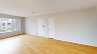 Located at 6312 Lindenwood Ct in St. Louis, MO, this well-maintained 2-bedroom, 1-bathroom unit offers a thoughtfully designed single-floor layout. Warm hardwood flooring flows throughout the living areas and bedrooms, providing a cohesive and inviting atmosphere. The spacious living room features neutral white walls, a window with natural light, and a hallway leading to the rest of the unit. The kitchen is outfitted with crisp white shaker cabinetry, white quartz countertops, a subway tile backsplash, stainless steel appliances including a refrigerator, range, microwave, and dishwasher, and dark tile flooring that contrasts cleanly with the bright finishes. The primary bedroom is generously sized and features dual closets, providing ample storage. The second bedroom also includes dual closets and multiple windows that bring in natural light. The full bathroom is neatly appointed with a tiled tub-shower surround in classic white subway tile, a patterned tile floor, and a vanity with a clean white countertop. Throughout the unit, consistent flush-mount lighting, white trim, and neutral wall tones create a clean, move-in ready environment that is both functional and comfortable.