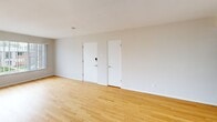 Located at 6312 Lindenwood Ct in St. Louis, MO, this well-maintained 2-bedroom, 1-bathroom unit offers a thoughtfully designed single-floor layout. Warm hardwood flooring flows throughout the living areas and bedrooms, providing a cohesive and inviting atmosphere. The spacious living room features neutral white walls, a window with natural light, and a hallway leading to the rest of the unit. The kitchen is outfitted with crisp white shaker cabinetry, white quartz countertops, a subway tile backsplash, stainless steel appliances including a refrigerator, range, microwave, and dishwasher, and dark tile flooring that contrasts cleanly with the bright finishes. The primary bedroom is generously sized and features dual closets, providing ample storage. The second bedroom also includes dual closets and multiple windows that bring in natural light. The full bathroom is neatly appointed with a tiled tub-shower surround in classic white subway tile, a patterned tile floor, and a vanity with a clean white countertop. Throughout the unit, consistent flush-mount lighting, white trim, and neutral wall tones create a clean, move-in ready environment that is both functional and comfortable.