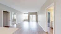 This thoughtfully designed single-floor residence in Loveland, Colorado offers a comfortable and functional layout across two bedrooms and two bathrooms. The open-concept living room and kitchen area is anchored by light hardwood-style flooring that flows seamlessly throughout the main living spaces, creating a bright and cohesive aesthetic. Large windows and a sliding glass door flood the living room with natural light while providing access to a private balcony overlooking a landscaped outdoor setting.

The kitchen features crisp white cabinetry with brushed hardware, a subway tile backsplash, light quartz countertops, stainless steel appliances, and a kitchen island that adds prep space and visual appeal. Both bedrooms are carpeted for warmth and comfort, each offering natural light through well-placed windows. The primary bedroom includes an en-suite bathroom with a white vanity, quartz countertop, and a tub-shower combination. Closets include a spacious walk-in with built-in shelving and hanging rods for ample storage.

A dedicated in-unit laundry space with a full-size washer and dryer adds everyday convenience. Neutral tones, clean lines, and modern finishes throughout give this residence a polished, move-in-ready feel.