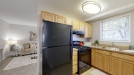 Located at 1525 Elkwood Lane in Capitol Heights, MD, this well-designed two-bedroom residence offers a thoughtfully laid-out single-floor plan that maximizes every square foot. The living room serves as the heart of the home, featuring neutral-toned carpet, soft wall colors, and a welcoming ambiance that flows seamlessly into the adjacent dining area. The kitchen is equipped with light wood cabinetry, granite-style countertops, tile flooring, and black appliances including a gas range and full-size refrigerator, with a window above the sink providing natural light. The primary bedroom is a comfortable retreat featuring carpet flooring, multiple windows that invite natural light, and a tray ceiling detail that adds architectural interest. The second bedroom is a cozy, versatile space with its own window and an open closet with built-in shelving, ideal for sleeping or flexible use. Throughout the residence, warm neutral tones and carpet flooring create a cohesive and inviting atmosphere. The layout also includes a dedicated closet for additional storage, making this an efficient and practical home in a convenient Maryland location.