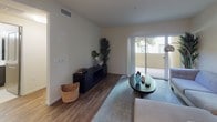 Located at 510 El Cerrito Plaza in El Cerrito, California, this single-floor residence offers a well-appointed and cohesive living environment with modern finishes throughout. The kitchen is a standout feature, boasting rich dark-stained cabinetry, white quartz countertops, a classic subway tile backsplash, and a full suite of stainless steel appliances including a gas range, over-the-range microwave, refrigerator, and dishwasher. A generous kitchen island provides additional prep space and casual dining potential. The flooring throughout the main living areas is warm wood-tone laminate, lending continuity and a welcoming feel. The living room is bright and comfortable, with a sliding glass door that opens to a private outdoor patio, allowing natural light to flow in and providing easy access to the outdoors. The bedroom features plush carpeting and a window that brings in additional natural light, creating a calm and restful retreat. The bathroom is clean and functional, outfitted with tile flooring, a soaking tub and shower combination with white tile surround, a toilet, and a vanity with dark cabinetry topped with a white countertop and a large mirror. The overall design aesthetic is contemporary and neutral, offering a comfortable and move-in ready living space.