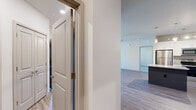 Located at 8161–8165 N Union Blvd in Colorado Springs, CO, this well-appointed 2-bedroom, 3-bathroom single-floor residence offers a thoughtfully designed layout with modern finishes throughout. The open-concept kitchen and living area serves as the heart of the home, featuring crisp white cabinetry, granite countertops, a dark-toned island with pendant lighting, stainless steel appliances, and light wood-look flooring that extends throughout the main living spaces. The living room benefits from soaring ceilings and an abundance of natural light streaming through large, multi-pane windows with views of the surrounding neighborhood. Both bedrooms are carpeted and equipped with ceiling fans, with the primary bedroom offering generous proportions and a spacious walk-in closet outfitted with built-in shelving and dual hanging rods. The bathrooms are finished with granite vanities, white cabinetry, and tile-surround tub/shower combinations. A dedicated laundry room accommodates a full-size washer and dryer and includes additional shelving for storage. Two closets provide ample organizational space throughout the home. The clean, neutral color palette and consistent modern finishes create a cohesive and comfortable living environment.