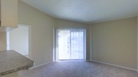 Located in Irving, Texas, this single-floor residence offers a straightforward and functional layout designed for comfortable everyday living. The living area is a standout feature, characterized by soft wall-to-wall carpeting that adds warmth underfoot and neutral-toned walls that create a clean, versatile backdrop. A large sliding glass door floods the space with abundant natural light, while vertical blinds provide adjustable privacy and light control. The door opens to an outdoor view, connecting the interior to the outside environment. The textured popcorn ceiling adds a classic finish to the room, and the open wall space offers ample flexibility for furniture arrangement and personalization. The overall ambiance of the space is calm and neutral, making it an approachable canvas for a variety of interior styles. The single-floor design ensures easy accessibility and seamless flow throughout the home, making it a practical and inviting living option in the Irving, TX area.