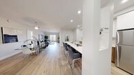 This well-appointed 3-bedroom, 2-bathroom unit at 80-100 Starwood Drive in Guelph offers a thoughtfully designed, single-floor layout that balances comfort and modern style. Light hardwood flooring flows throughout the entire space, creating a warm and cohesive aesthetic.

The open-concept kitchen, dining, and living area forms the heart of the unit. The kitchen features two-tone cabinetry with warm wood lower cabinets and crisp white uppers, quartz countertops, stainless steel appliances, and a generous breakfast bar with seating — ideal for casual dining. The space opens into a bright dining area and a spacious living room, with a sliding glass door leading to a private balcony overlooking the surrounding neighbourhood.

The primary bedroom is a comfortable retreat, featuring a large window with outdoor views, light hardwood floors, and a tray ceiling detail. The second bedroom is equally well-sized, bright, and neutrally finished. A third flexible living space provides additional room for lounging or a home office.

Both bathrooms are finished with white subway tile and quartz countertops. One features a soaker tub and tub surround, while the other offers a glass-enclosed walk-in shower with a rainfall showerhead — both with wood-tone flooring for a clean, modern feel.