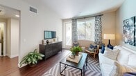 Located at 5805 Charlotte Dr in San Jose, CA, this thoughtfully designed one-bedroom, one-bathroom residence offers a comfortable and modern living experience across a single floor. The open-concept layout seamlessly connects the kitchen, dining, and living areas, creating a bright and airy atmosphere enhanced by recessed lighting and rich hardwood-style flooring throughout the main living spaces.

The kitchen is a standout feature, outfitted with crisp white cabinetry reaching to the ceiling, dark quartz countertops, stainless steel appliances including a refrigerator, range, microwave, and dishwasher, and a central island that provides additional prep space and casual seating. The living room flows naturally from the kitchen and dining area, with large windows and a sliding glass door opening to a private balcony with views of mature palm trees.

The bedroom is a serene retreat, carpeted for comfort, and features large windows with lush outdoor views, a ceiling fan, and ample closet space. The full bathroom is finished with white cabinetry, dark countertops, hardwood-style flooring, a tub-shower combination, and a large vanity mirror. A dedicated laundry area and a welcoming entrance hallway round out this well-appointed residence.