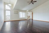 Located at 2205 Oxford Ct in Plover, WI, this two-story home offers a well-organized layout across two floors. The main level serves as the heart of the home, anchored by a spacious open-concept living room and kitchen combination. The living room impresses with soaring vaulted ceilings, a ceiling fan, and rich dark hardwood flooring that extends throughout. Large windows, including an arched accent window, flood the space with natural light and provide views of the surrounding neighborhood. The kitchen is efficiently designed with warm honey-toned cabinetry, stainless steel appliances including a refrigerator, range, and microwave, tile flooring, and a peninsula with counter seating that connects seamlessly to the living area. Upstairs, two bedrooms offer comfortable retreats, each with plush carpeting, ceiling fans, and natural light. The primary bedroom is generously sized with a sliding closet. A full bathroom on this level features tile flooring, a wood vanity with ample storage, and a well-lit mirror. The attached garage provides convenient enclosed parking and additional storage space with an automatic opener. Stairways connect the levels, completing this functional and well-appointed home.