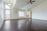 Located at 2205 Oxford Ct in Plover, WI, this two-story home offers a well-organized layout across two floors. The main level serves as the heart of the home, anchored by a spacious open-concept living room and kitchen combination. The living room impresses with soaring vaulted ceilings, a ceiling fan, and rich dark hardwood flooring that extends throughout. Large windows, including an arched accent window, flood the space with natural light and provide views of the surrounding neighborhood. The kitchen is efficiently designed with warm honey-toned cabinetry, stainless steel appliances including a refrigerator, range, and microwave, tile flooring, and a peninsula with counter seating that connects seamlessly to the living area. Upstairs, two bedrooms offer comfortable retreats, each with plush carpeting, ceiling fans, and natural light. The primary bedroom is generously sized with a sliding closet. A full bathroom on this level features tile flooring, a wood vanity with ample storage, and a well-lit mirror. The attached garage provides convenient enclosed parking and additional storage space with an automatic opener. Stairways connect the levels, completing this functional and well-appointed home.