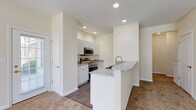 Located at 3900 Suffolk Dr in Dublin, Ohio, this single-floor residence offers a clean, modern design with a bright and open feel throughout. The expansive living area is carpeted and bathed in natural light from large windows, creating a welcoming and airy atmosphere that flows seamlessly toward the kitchen.

The kitchen is well-equipped with white shaker-style cabinetry, granite countertops, and stainless steel appliances including a range, microwave, and dishwasher. A peninsula with an integrated sink and matching granite surface provides additional workspace and serves as a natural divider between the kitchen and living areas. Wood-look flooring in the kitchen adds warmth and contrast to the neutral color palette. A glass-panel door off the kitchen leads directly outside, offering convenient access and additional natural light.

The bedrooms are comfortably sized with plush carpeting and windows that allow for natural light. Ample closet space is provided in each room. The two bathrooms are finished with wood-look flooring and white cabinetry. One bathroom features a tub-shower combination, while the other includes a standalone walk-in shower with a framed glass enclosure and a single vanity with a mirror. The overall design is neutral and move-in ready, offering a functional and comfortable living environment.