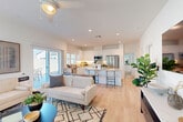 This contemporary 900 square foot residence in La Quinta, California offers a thoughtful layout with 2 bedrooms and 2 bathrooms. The home's design emphasizes openness and natural light, evident in the spacious living area that seamlessly connects to the kitchen. The kitchen boasts white cabinetry, stainless steel appliances, and a central island with seating, perfect for casual dining or entertaining.

The primary bedroom, measuring 150 square feet, features large windows with blinds, allowing ample natural light while maintaining privacy. Both bathrooms are outfitted with modern fixtures, including a bathtub in one and a walk-in shower in the other. The secondary bedroom is equally well-appointed, with stylish decor and comfortable furnishings.

Throughout the home, hardwood floors and a neutral color palette create a cohesive, airy atmosphere. The living room includes a mounted flat-screen TV and contemporary furniture, ideal for relaxation. An attached single-car garage provides convenient off-street parking and additional storage space.

Outside, a small patio area offers an opportunity for outdoor living and enjoying the pleasant La Quinta climate. The property's efficient use of space and modern amenities make it an attractive option for those seeking a low-maintenance yet comfortable lifestyle in this desirable California location.
