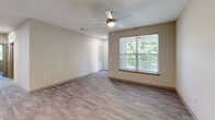 Located at 7116 Finn Hall Avenue in Charlotte, NC, this two-story residence offers three bedrooms and three full bathrooms across a well-utilized floor plan. The main living level features an open-concept kitchen and living area with light luxury vinyl plank flooring that flows throughout the home. The kitchen is equipped with gray shaker-style cabinetry, granite countertops, a classic white subway tile backsplash, stainless steel appliances including a refrigerator, range, microwave, and dishwasher, and a double-basin sink. Each of the three bedrooms features LVP flooring, ceiling fans with light fixtures, and windows fitted with blinds that invite natural light and views of the surrounding greenery. The primary bedroom includes dedicated closet space, adding to its functionality. The bathrooms are finished with granite-topped white vanities and wood-look tile flooring. One bathroom features a tiled tub-shower combination, while another offers a standalone shower. Each bedroom benefits from its own closet. Neutral tones and consistent finishes throughout create a clean, cohesive aesthetic. A staircase connects the two levels, with the main living spaces concentrated on the upper floor.